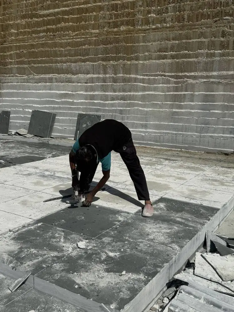 A worker finishing the surface of a Kota stone slab