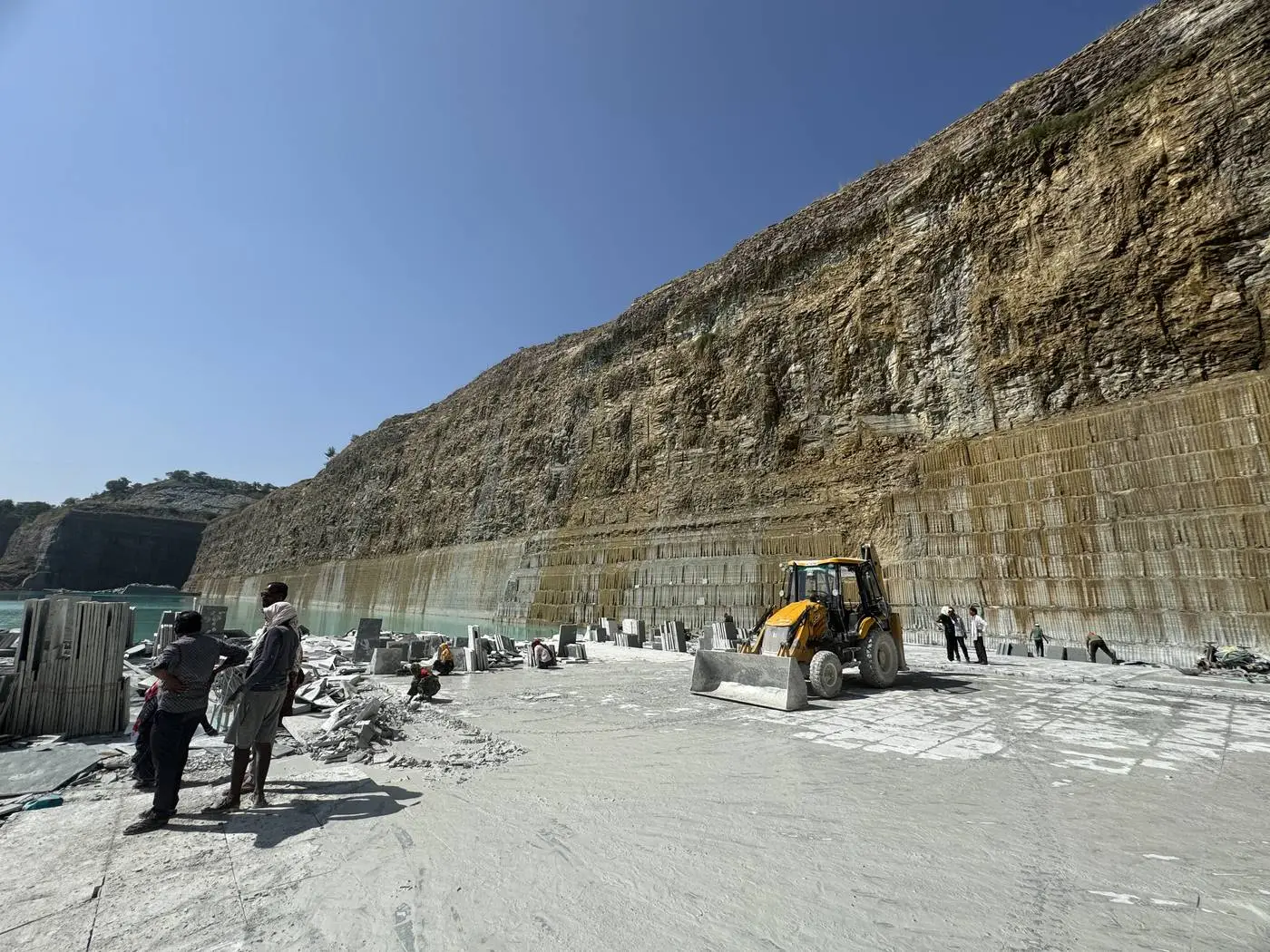 The quarry floor at Mayla with the cut stone wall rising behind it