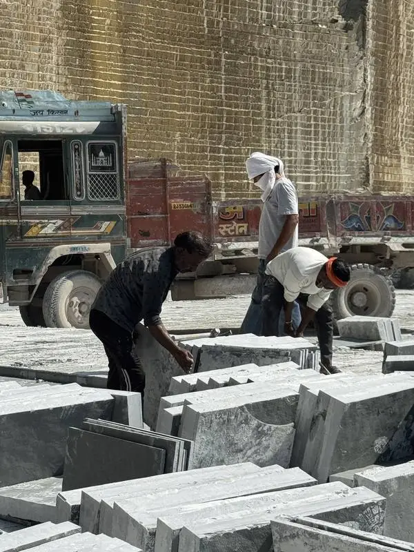 Workers loading Kota stone onto a truck at the quarry